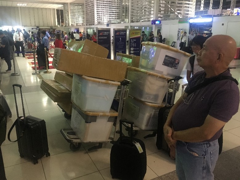 Photograph of 20 packed boxes in an airport.