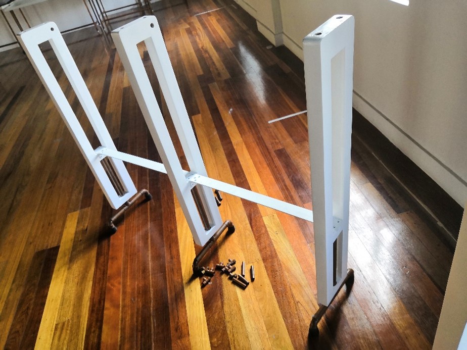 Photograph of a white wooden hanger rack