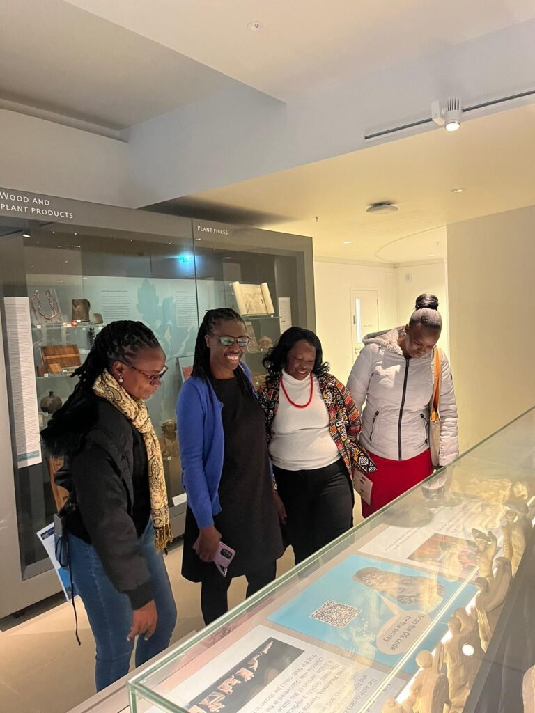 Photograph of four women in a museum gallery.