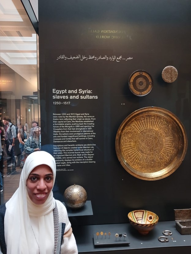 Photograph of Hebe stood in front of an Egyptian and Syrian display case.