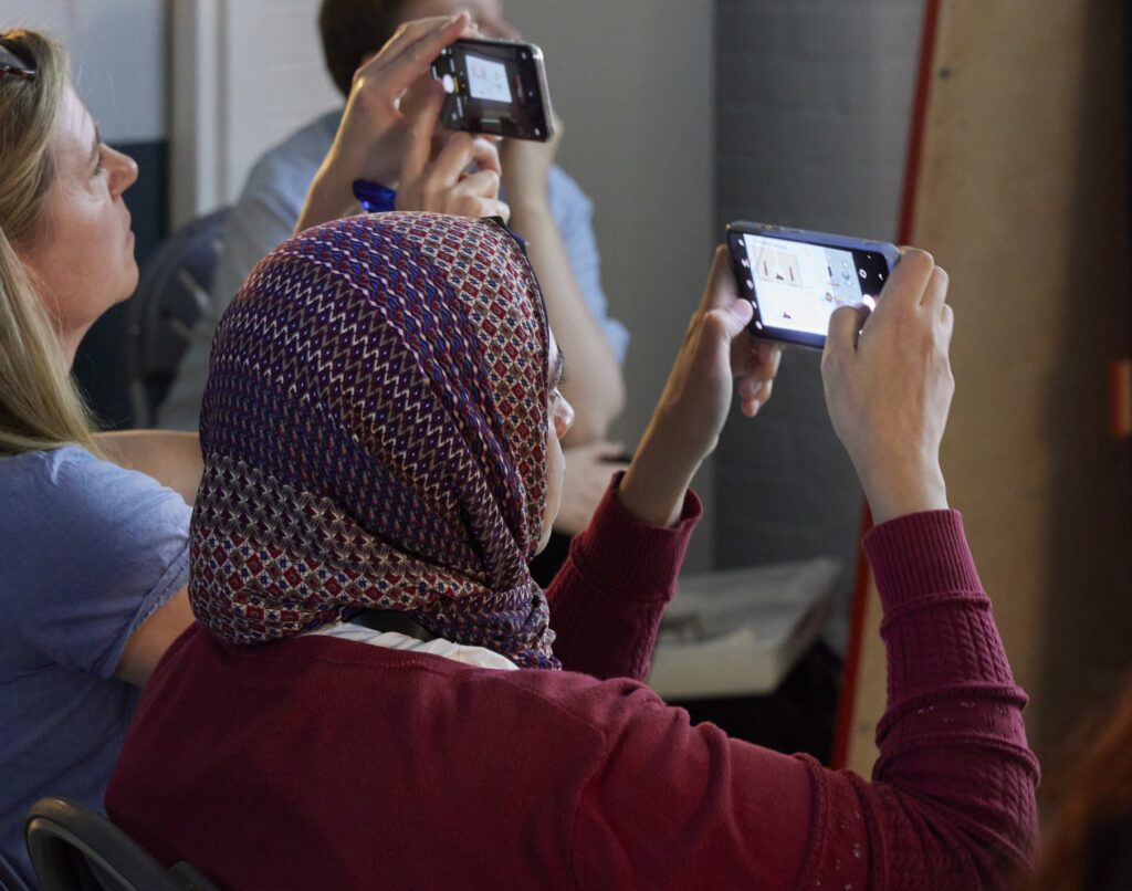 Photograph of people taking photos on a smartphone