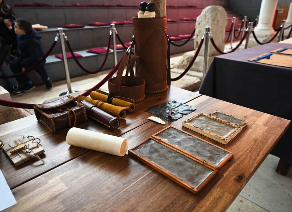 Photograph of replica Roman writing materials on a table.