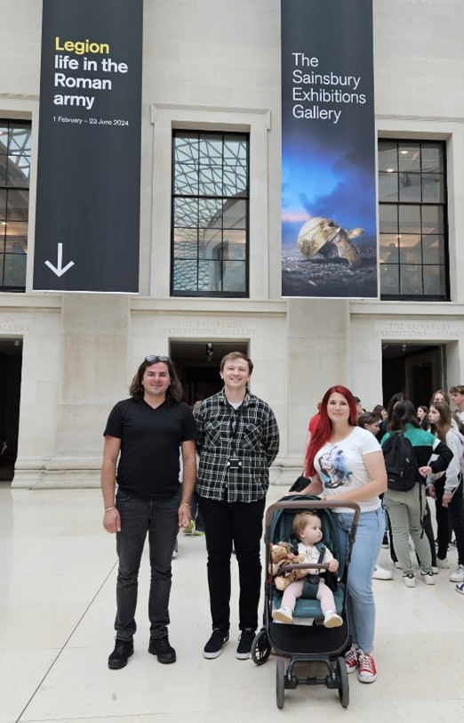 Photograph of three people and a baby in a pushchair in the Great Court at the British Museum