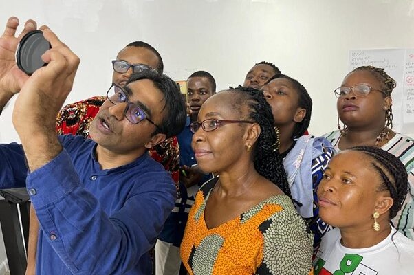 Photograph of a group of people looking at a camera