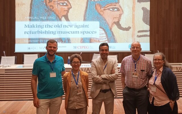 Photograph of 5 people stood in front of a projector.