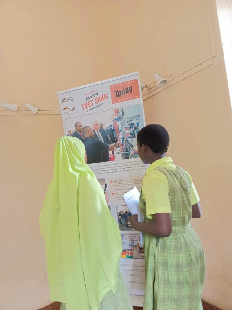 Two people looking at a poster.