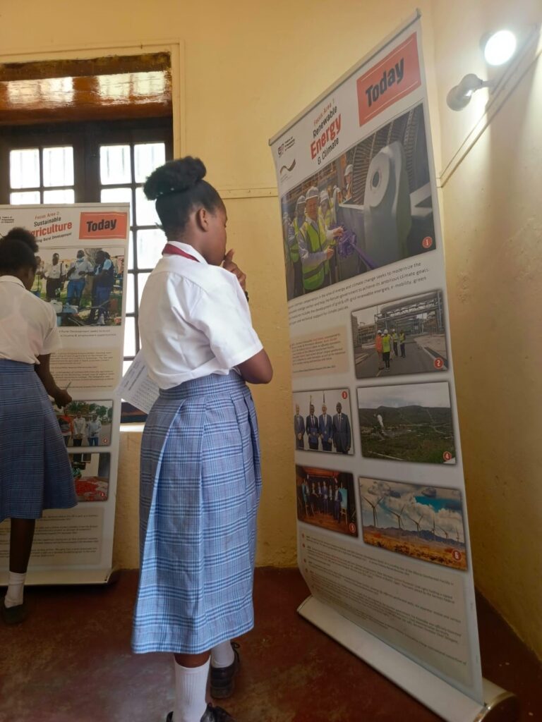 A girl looking at a poster.