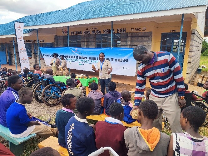 People presenting to a group of children