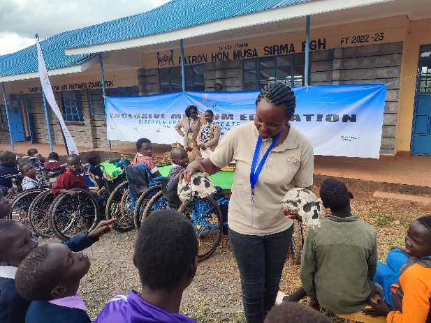 People presenting to a group of children