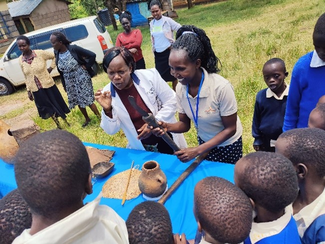 Adults showing children objects