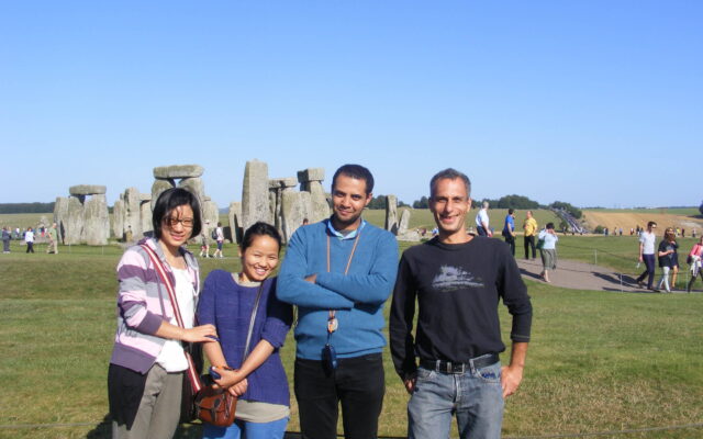 Photo of four people at Stonehenge