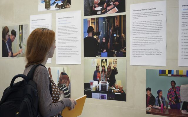 Photograph of a woman looking at a photo display