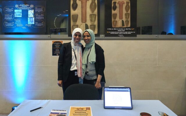 Photograph of two women in front of a table display